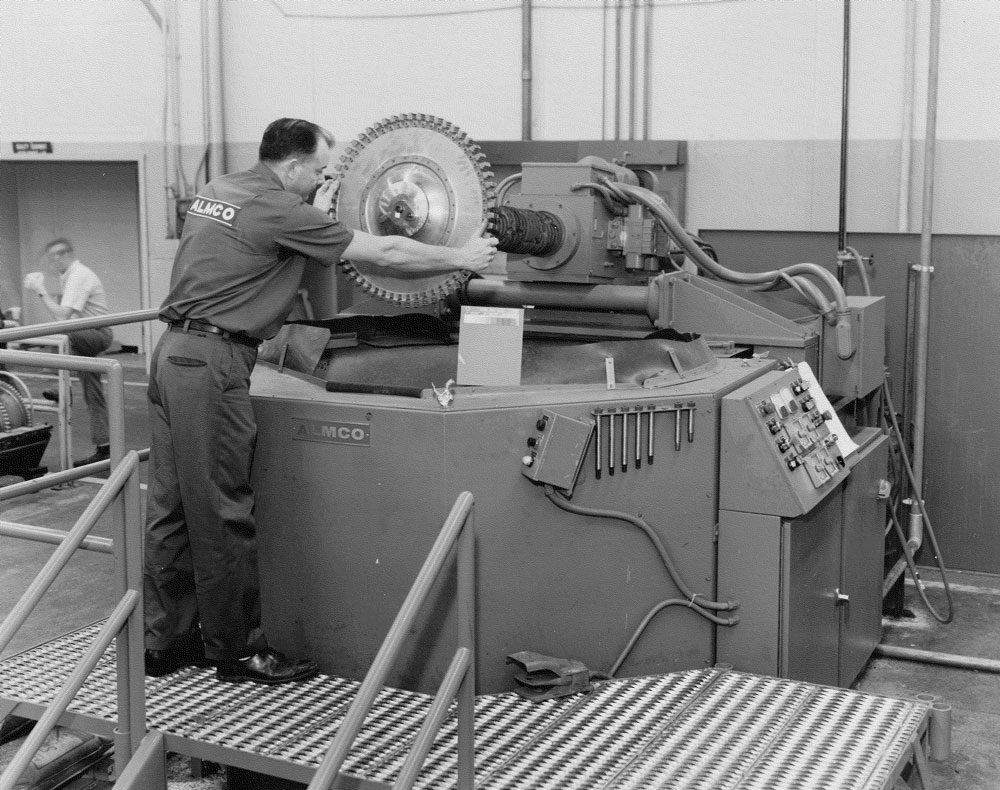 Maintenance man removes the spindle from a damaged machine